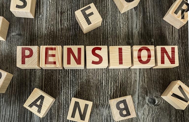 Pension spelt out in red on wooden blocks